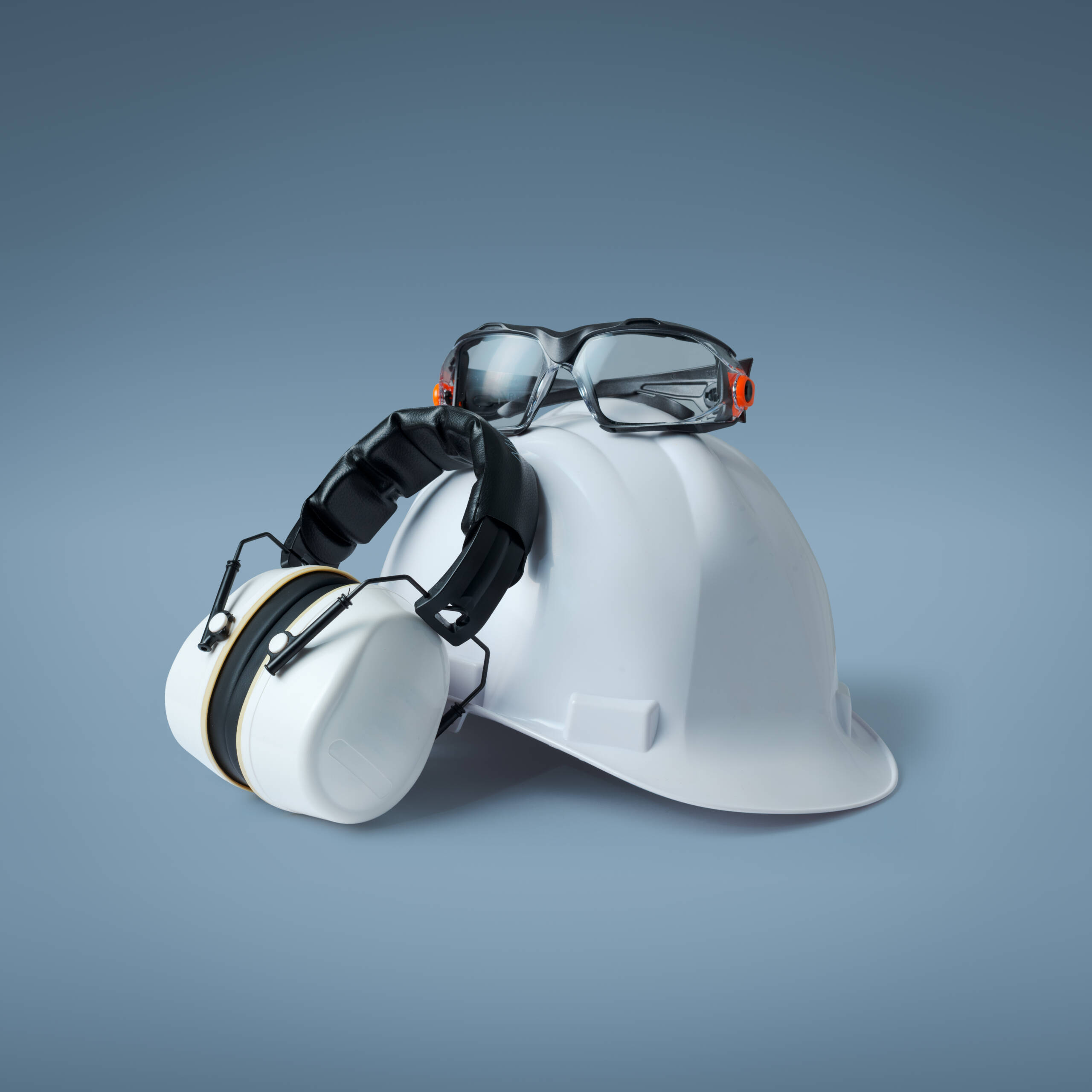 Safety helmet, ear muffs and goggles: personal protective equipment and workplace safety concept